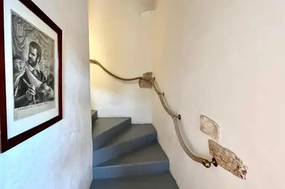 a stairway with a picture of a man on the wall at Maison de maitre au charme d'antan Bonifacio in Bonifacio