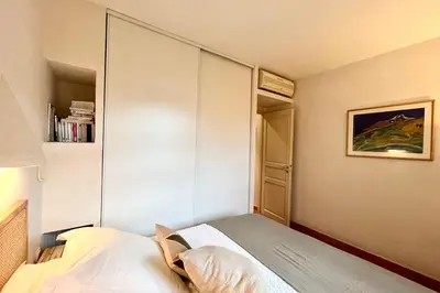 a small bedroom with a bed and a closet at Maison de maitre au charme d'antan Bonifacio in Bonifacio