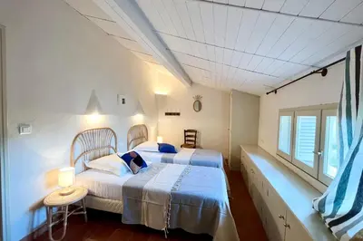 a bedroom with two beds and a window at Maison de maitre au charme d'antan Bonifacio in Bonifacio