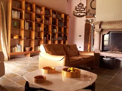 a living room with a couch and a table at Villa con piscina tra Porto vecchio e Bonifacio in Figari