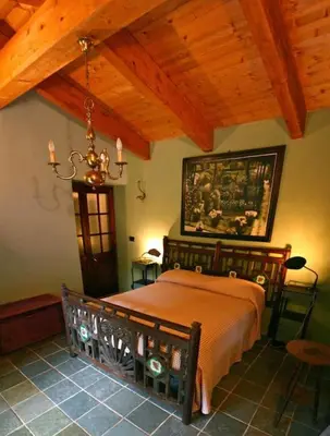 a bedroom with a bed and a wooden ceiling at Villa con piscina tra Porto vecchio e Bonifacio in Figari