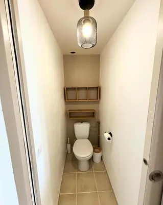 a small bathroom with a toilet and a light at Casa Punta Di Vista in Venaco