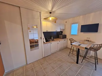 a kitchen with a table and a dining room at Casa Punta Di Vista in Venaco