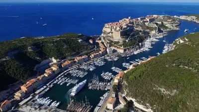 an aerial view of a harbor with boats in the water at Magnifique T3 les hauts du port Bonifacio in Bonifacio