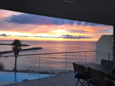 a view of a sunset from the balcony of a house at NEPITA- Vue mer- piscine en résidence de standing- clim-Wifi in Sari Solenzara