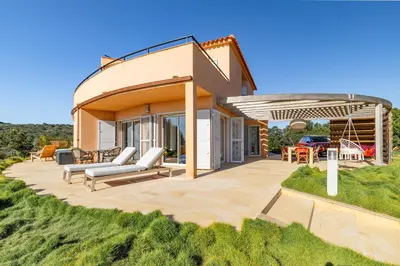 a house with a pergola and a patio at Villa La Ronde des Soleils in Coti-Chiavari