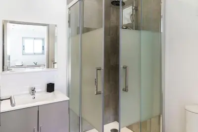 a bathroom with a glass shower and a sink at Studio en pierre U Pinu, 2 personnes, Muratello, 6 Kms de Porto Vecchio in Porto-Vecchio