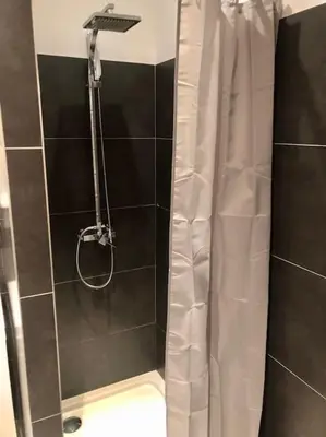 a shower with a shower curtain in a bathroom at Studio Piscine, 200m port de Porto Vecchio pour 2 personnes in Porto-Vecchio