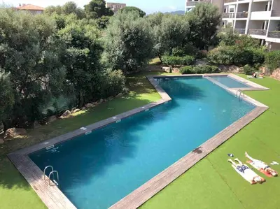 an overhead view of a large swimming pool with green grass at Studio Piscine, 200m port de Porto Vecchio pour 2 personnes in Porto-Vecchio
