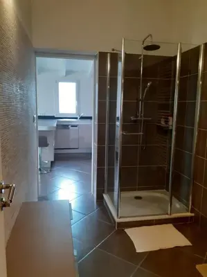 a bathroom with a shower with a glass door at Le nid d'Aigle - proche Ajaccio in Cuttoli-Corticchiato