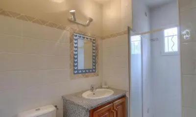 a bathroom with a sink and a mirror at Les bergeries d'Ogliastrello in Figari