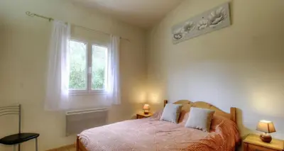 a bedroom with a bed and a window at Les bergeries d'Ogliastrello in Figari