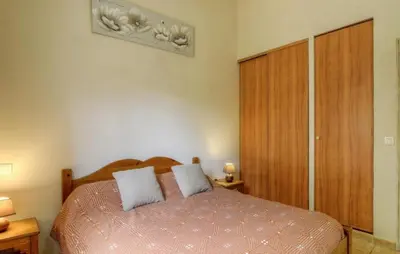 a bedroom with a bed with two pillows on it at Les bergeries d'Ogliastrello in Figari