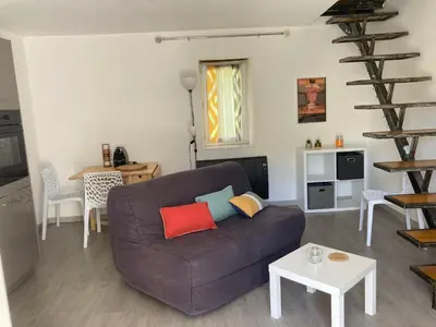 a living room with a couch and a table at Maison Kyprea: charmant appartement /duplex , spacieux, tout confort avec terrasse extérieure privée, parking privatif , vue pittoresque sur la citadelle de Corté et les montagnes. in Corte