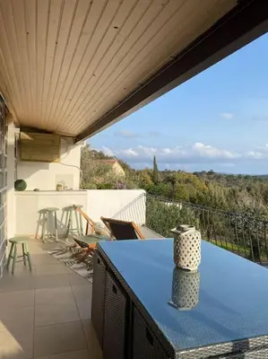 a living room with a couch and a table at Maison de village en granite in Porto-Vecchio