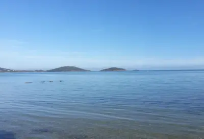 a large body of water with islands in the distance at Maison de village en granite in Porto-Vecchio