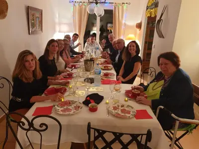 a group of people sitting around a long table at Maison de village en granite in Porto-Vecchio