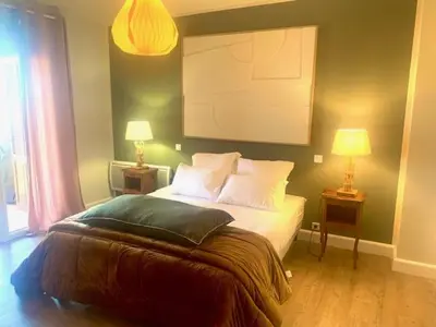 a bedroom with a bed with two night stands and two lamps at A CASA DI MAMMA in Pianottoli-Caldarello