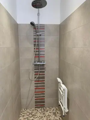 a shower in a bathroom with a glass door at A CASA DI MAMMA in Pianottoli-Caldarello