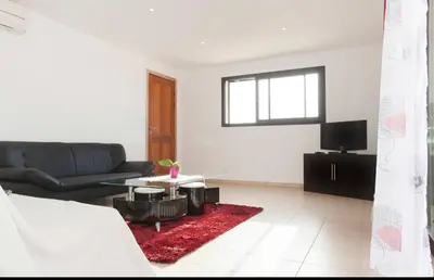 a living room with a couch and a tv at Chez telou in Borgo