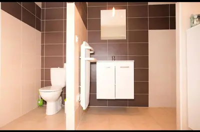 a bathroom with a toilet and a sink at Chez telou in Borgo