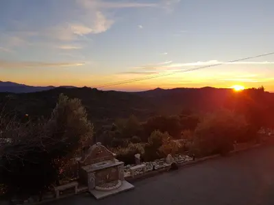 a sunset from the top of a building with the sun setting at Amon nos Ôtes in Vezzani