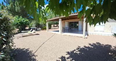 a pavilion with a bench on a gravel patio at Villa avec piscine hors sol à 10mn de la plage in Lecci