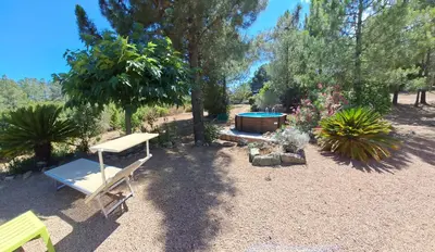 a garden with a bench and a swimming pool at Villa avec piscine hors sol à 10mn de la plage in Lecci