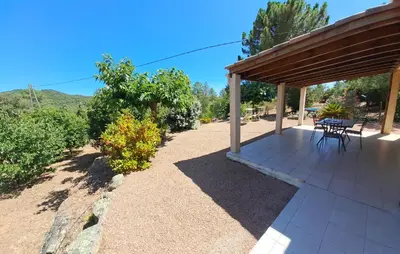 a pavilion with a table and chairs on a patio at Villa avec piscine hors sol à 10mn de la plage in Lecci
