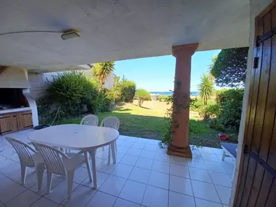 a patio with a table and chairs and a view of the ocean at Oro 60 in Conca