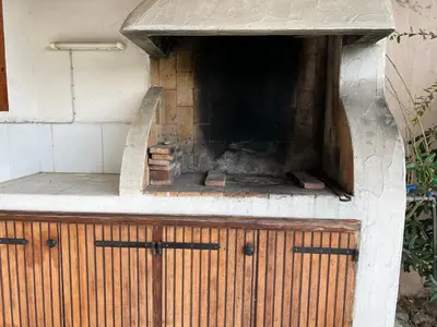 a brick oven with a fire inside of it at Oro 60 in Conca