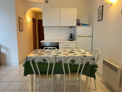 a kitchen with a table with chairs and a refrigerator at Oro 60 in Conca