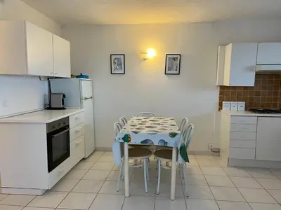 a kitchen with a table with chairs and a refrigerator at Oro 60 in Conca
