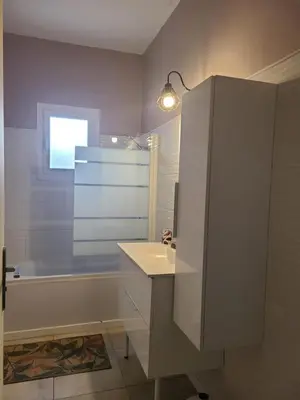 a bathroom with a sink and a bath tub at A CASA DI LOULOU e MARIA in Furiani