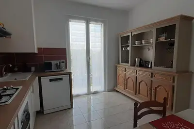 a kitchen with a refrigerator and a counter top at A CASA DI LOULOU e MARIA in Furiani