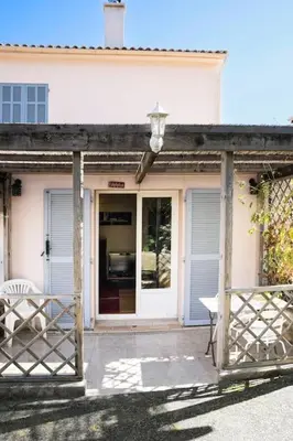 a porch of a house with a door and a chair at Studio Indépendant avec Terrasse in Furiani