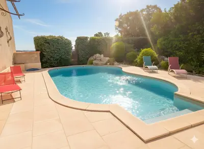 a swimming pool in a patio with lawn chairs and aitating at appartement climatisé 35 m2 pour 1 couple - piscine partagée - in Porto-Vecchio