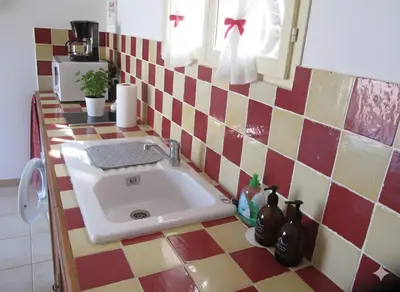 a kitchen counter with a sink in a kitchen at mini villa studio 1 pièce 21 m2 pour 2 personnes piscine partagée climatisation in Porto-Vecchio