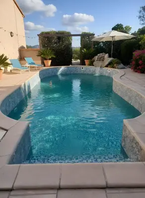 a view of the sun setting over a city and the ocean at mini villa studio 1 pièce 19 m2 pour 2 personnes piscine partagée climatisation in Porto-Vecchio