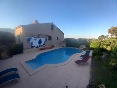 a table and two chairs and a table and a bench at studio 1 pièce 16 m2 climatisé 2 personnes piscine partagée in Porto-Vecchio