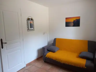 a kitchen with white cabinets and a microwave at studio 1 pièce 16 m2 climatisé 2 personnes piscine partagée in Porto-Vecchio