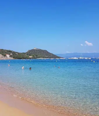 a group of people in the water at the beach at Lavallee in Campomoro