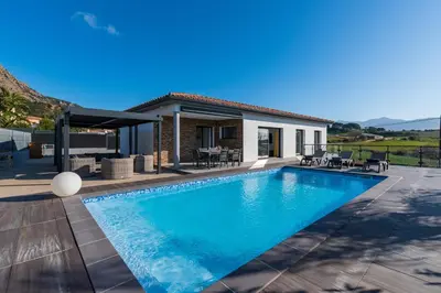 a swimming pool in front of a house at Afa, proche d Ajaccio, Magnifique Villa 4 pers avec Piscine privée et vue montagne in Afa