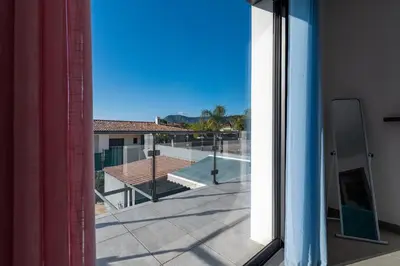 a view of the pool from the window of a building at Afa, proche d Ajaccio, Magnifique Villa 4 pers avec Piscine privée et vue montagne in Afa