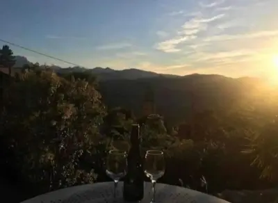 a table with two glasses and a bottle of wine at Maison Lama in Lama