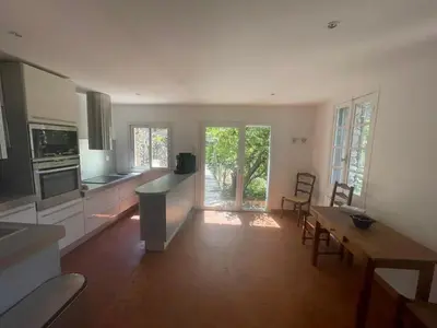 a large kitchen with a table and a dining room at Maison Lama in Lama