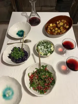 a white table with plates of food on it at Maison typique Corse écologique in Coti-Chiavari