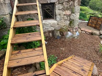 a wooden ladder and a bench in front of a building at Maison typique Corse écologique in Coti-Chiavari