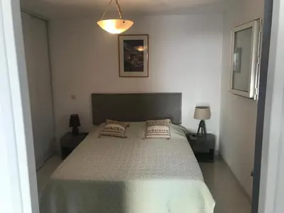 a bedroom with a bed with two pillows on it at Clement - Rez de villa - Vue Mer in Sari Solenzara