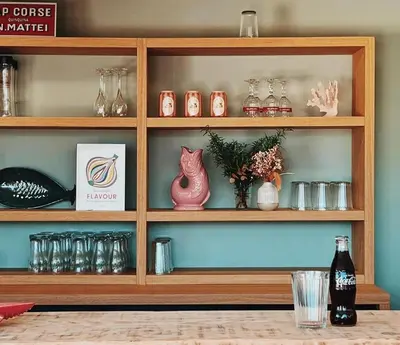 a wooden shelf with glasses and vases on it at Hotel Riva Beach in Porto-Vecchio